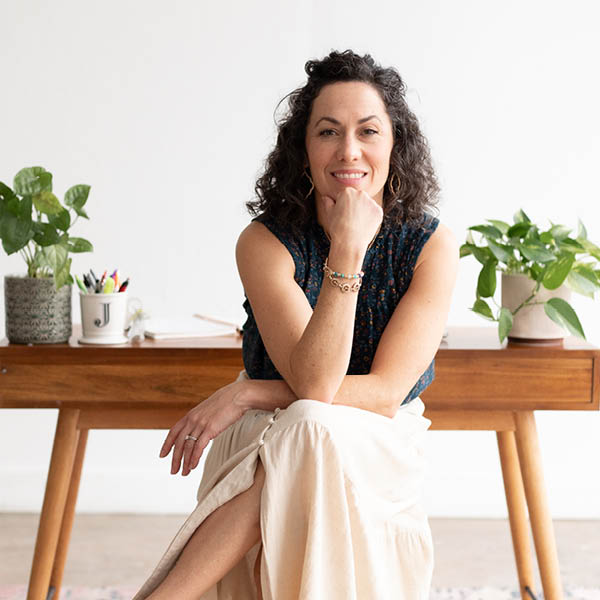 Jessica Callahan, counselor therapist yoga sitting at her desk